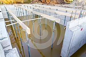 Construction site with flooded foundation for house