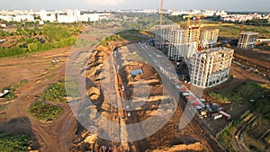 Construction site fron drone view. Laying of storm sewer pipes and sewerage wells and concrete well ring. Drainage concrete pipe.