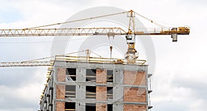 Construction site, generic unfinished empty residential building and a crane, block of flats under construction, new modern estate