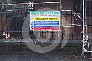 Construction site health and safety message rules sign board signage on fence boundary