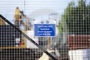 Construction site health and safety message rules sign board signage on fence boundary