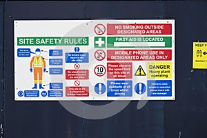 Construction site health and safety message rules sign board signage on fence boundary