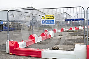 Construction site health and safety message rules sign board signage on fence boundary