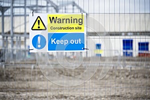 Construction site health and safety message rules sign board signage on fence boundary