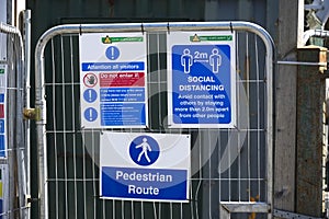 Construction site health and safety message rules sign board signage on fence boundary