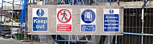 Construction site health and safety message rules sign board signage on fence boundary