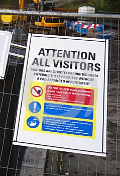 Construction site health and safety message rules sign board signage on fence boundary