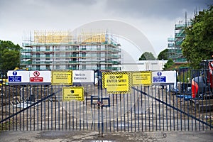 Construction site health and safety message rules sign board signage on fence boundary