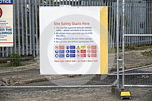 Construction site health and safety message rules sign board signage on fence boundary