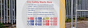 Construction site health and safety message rules sign board signage on fence boundary