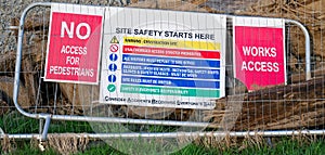 Construction site health and safety message rules sign board signage on fence boundary