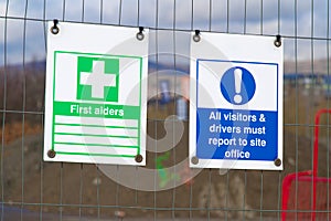 Construction site health and safety sign on fence