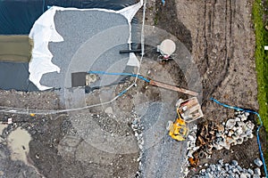 Construction site with heavy machinery, Aerial top down view. Building industry. Development area for commercial or residential