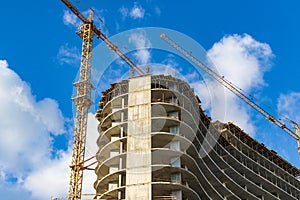 Construction site with high-rise cranes. Construction of modern apartment buildings and a new residential complex.