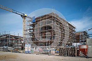 on a construction site a house is completely scaffolded