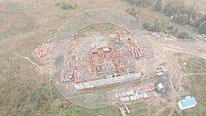 Construction site of house development. Workers and heavy machinery work on building site. Construction industry