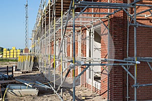 Construction site with houses in scaffolding