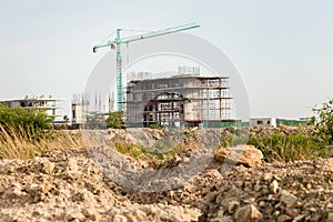 Construction site including several cranes working on a building complex.