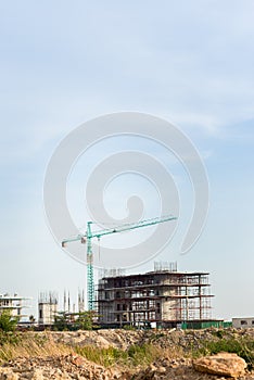 Construction site including several cranes working on a building complex.