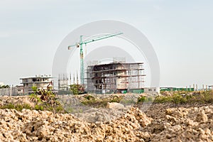 Construction site including several cranes working on a building complex.