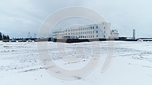 Construction site of industrial building in snowy field