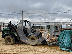 Construction site of an industrial complex. small houses for builders with windows. a tractor on large wheels rides nearby and