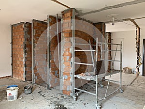 Construction site, industrial under construction empty space, red brick wall, architectural ground work tools, work in progress