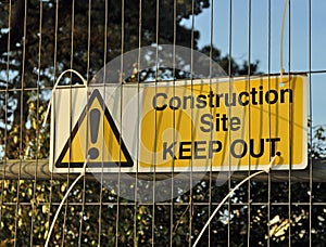 Construction site keep out sign on metal fence