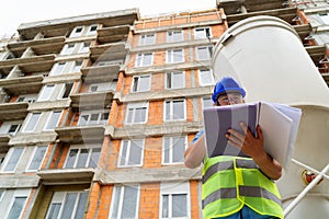 Construction site manager looking at the blue-print stock image