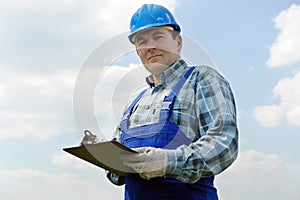 Construction site manager with notepad