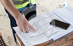 The construction site manager shows the work plan image.Construction site picture.