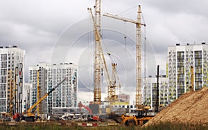A construction site in Moscow, a lot of cranes and a concrete cut from the blue sky