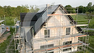 Construction site of a new detached house with solar panels on the roof
