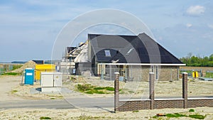 construction site of a new Dutch Suburban area with modern family houses, newly build family homes