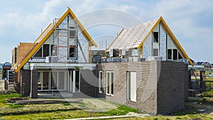 construction site of a new Dutch Suburban area with modern family houses, newly build family homes