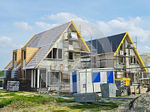 construction site of a new Dutch Suburban area with modern family houses, newly build family homes