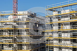 Construction site of a new house with scaffolding on the facade
