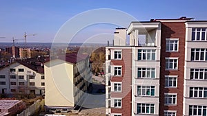 Construction site of new residential building and tower cranes.