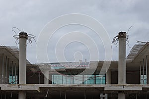 Construction site in progress. Unfinished building against depressive sky.