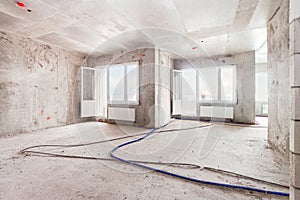 Construction site residential apartment building interior with two windows in concrete progress