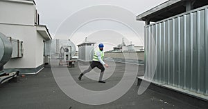 At construction site on the rooftop of building charismatic architect or engineer dancing in front of the camera while