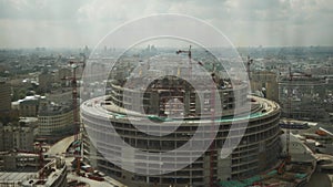 the construction site of a round-shaped stadium in the center of a megapolis