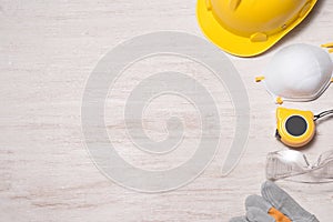 Construction site safety. Protective hard hat, gloves, glasses and masks on wooden background,