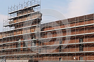 Construction site with scaffolding on the facade of a historic building of the University