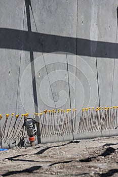 Construction site scene with compactor and re-enforcing rods