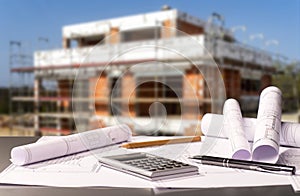 Construction site with shell and construction plans