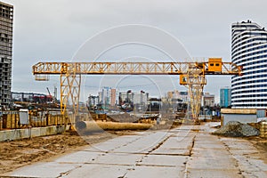 A construction site with specialized professional equipment and cranes during the construction of a modern line