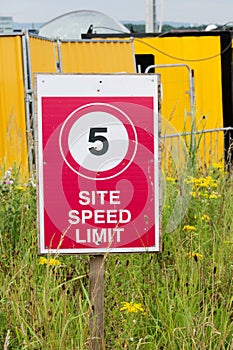 Construction site speed limit sign on fence boundary