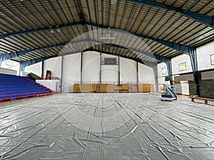 Construction site of sports hall, basketball court renovation, school gym indoor changing hardwood parquet flor and