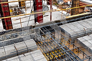 Construction site with steel formworks and reinforcing bars for